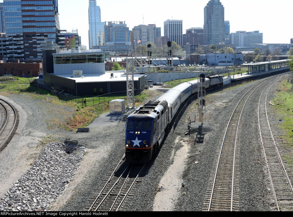 RNCX 1755 leads train P075-04 away from the station